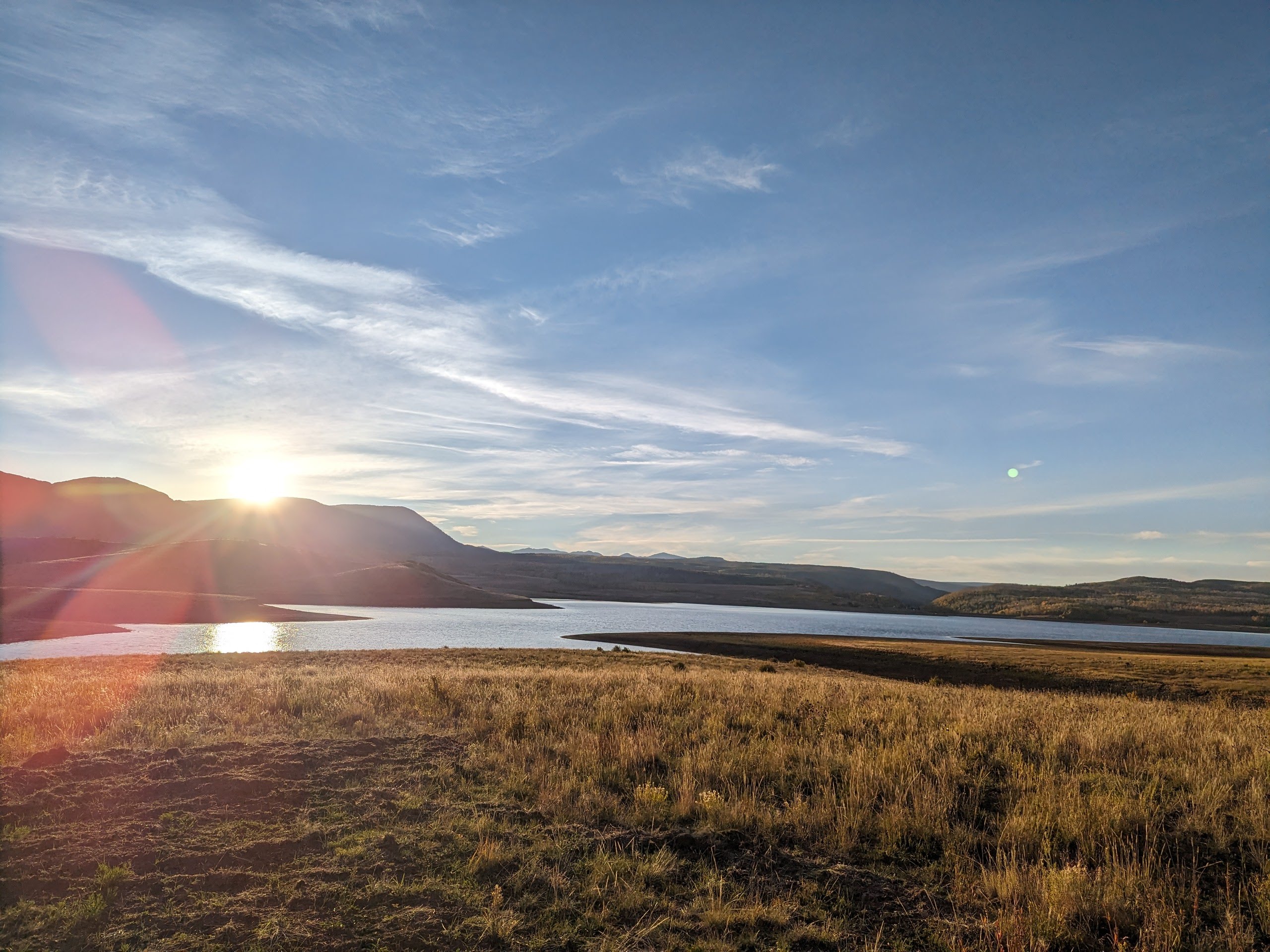 Autumn light and golden grass along the lakeshore at sunset